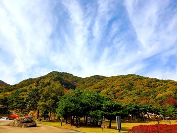 Scenic view of trees and mountains against sky