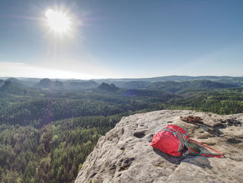 Taken down backpack and rope on top of the mountain. take off your backpack and climbing equipment 