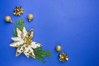 Directly above shot of christmas decorations on blue background