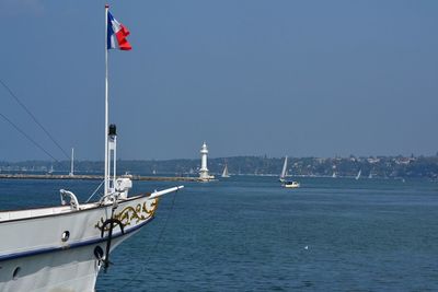French flag on boat at sea against sky