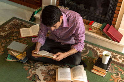 High angle view of man sitting on table at home