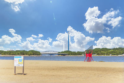 Lifeguard hut on beach against sky