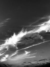 Low angle view of sunlight streaming through clouds