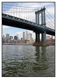 Bridge over river with city in background