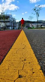 Rear view of a man standing on road