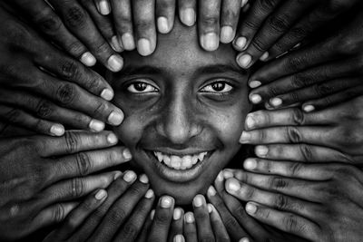 Close-up portrait of smiling man with hands