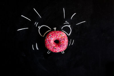 Close-up of strawberry over black background