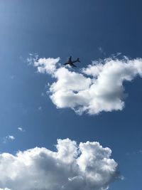 Low angle view of airplane flying in sky