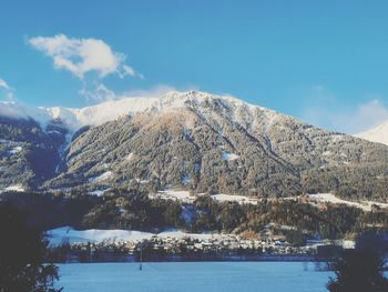 Scenic view of snowcapped mountains against sky