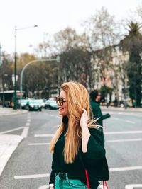 Young woman standing on road