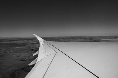Scenic view of airplain wing against clear sky