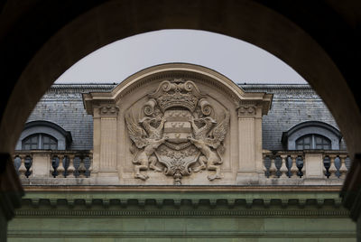 Low angle view of statue against historic building