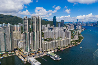 Aerial view of buildings in city against sky