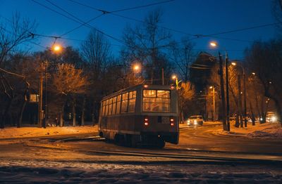 View of railroad tracks at night during winter