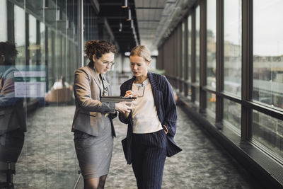 Full length of a young woman using mobile phone