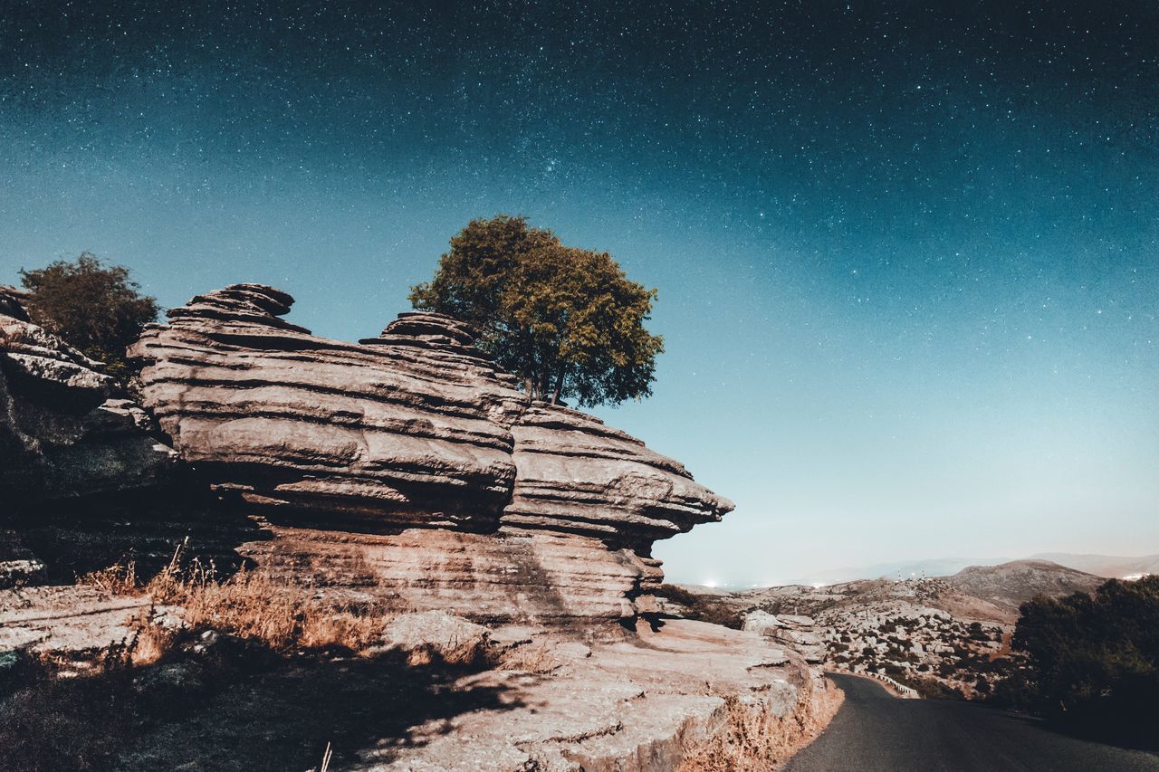 sky, rock, rock formation, rock - object, beauty in nature, scenics - nature, tranquil scene, solid, nature, geology, tranquility, no people, physical geography, non-urban scene, blue, clear sky, star - space, land, tree, environment, outdoors, eroded, arid climate, climate, formation