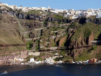 Buildings on cliff by sea