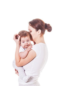 Portrait of mother and daughter against white background