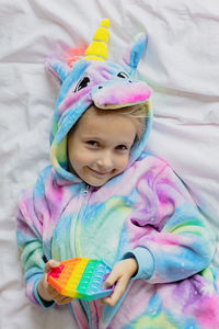 Portrait of cute baby girl on bed