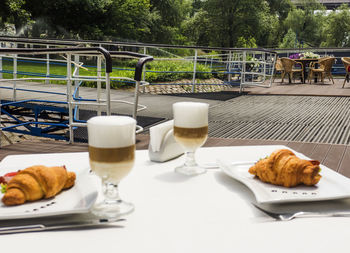 Coffee and croissants served on table