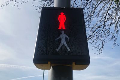 Low angle view of road sign against sky