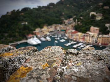 High angle view of harbor with rocks in foreground 