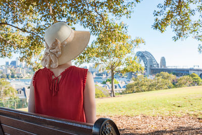 Rear view of woman sitting in park