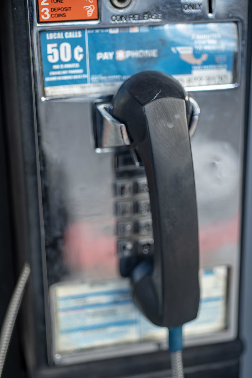 CLOSE-UP OF TELEPHONE ON WINDOW