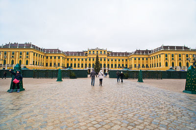 Group of people in historic building against sky