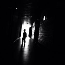 Woman walking in tunnel