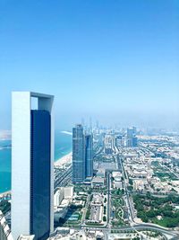 High angle view of buildings against clear blue sky