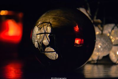 Close-up of illuminated lamp on table