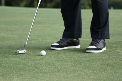 Low section of men playing with ball