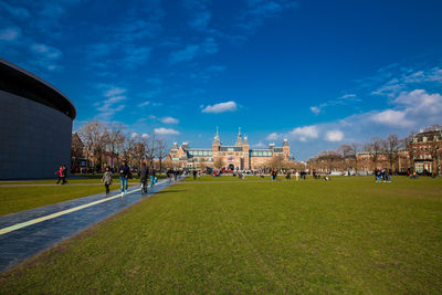 People enjoying an spring day at  the famous museum square next to the national museum in amsterdam