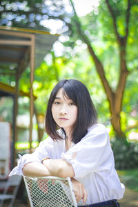 Portrait of a beautiful young woman against trees