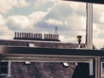 Close-up of coin-operated binoculars against sky