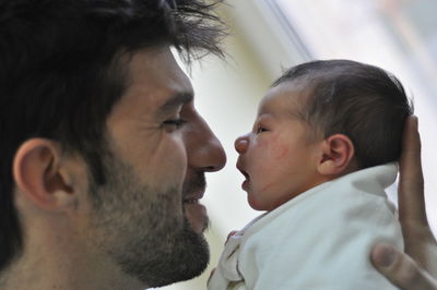 Close-up of father holding newborn son