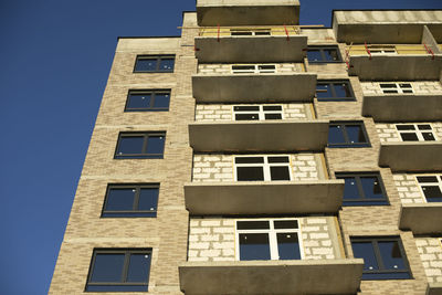 Facade of building. unfinished house. windows in new multi-storey building. 