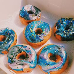 Close-up high angle view of multi colored donuts