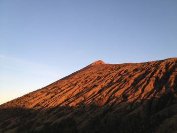 Scenic view of mountain against blue sky