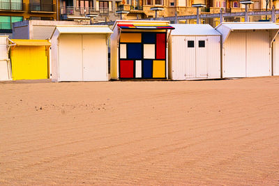 Multi colored houses on beach by building