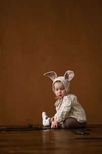 Toddler baby girl in funny hat with ears having fun