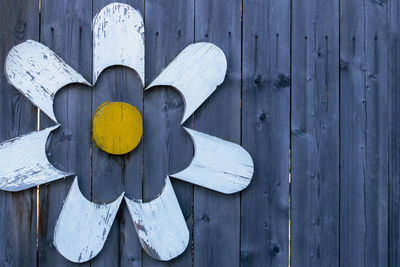 Close-up of painting on wooden fence