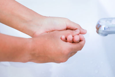 Low section of baby feet on hand