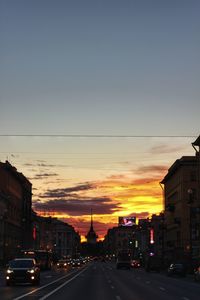 Cars on road at sunset