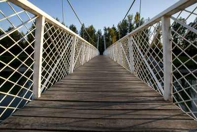 Empty footbridge against sky