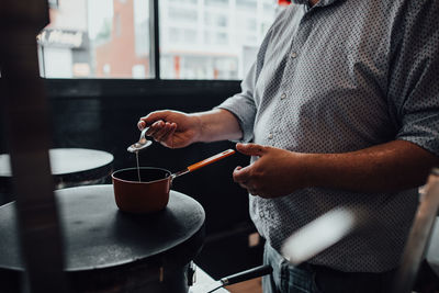 Male chef preparing crepes in restaurant kitchen