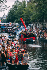 Group of people in boat against trees