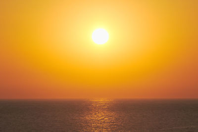 Scenic view of sea against romantic sky at sunset