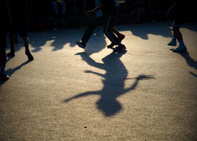 Shadow of people on road